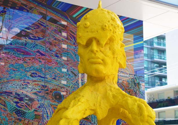 stargate sculpture series, redpath ave in toronto, public art, yellow and blue alien figures and two glass murals - head of yellow guy