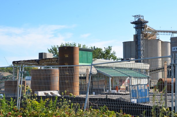 construction site, Lafarge cement silos in the background, all that remains of the T N T supermarket is the front entrance 