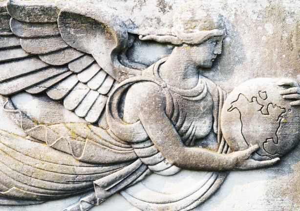 bas relief sculpture on stone of a winged woman holding a globe, earth 