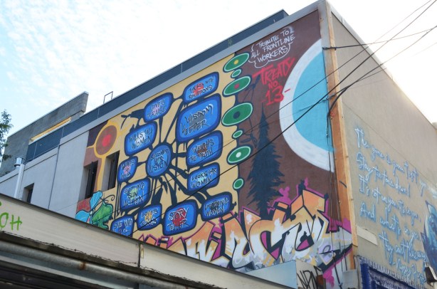 mural as salute to frontline workers, on upper level of a wall, mentions treaty 13, first nations symbolism, 