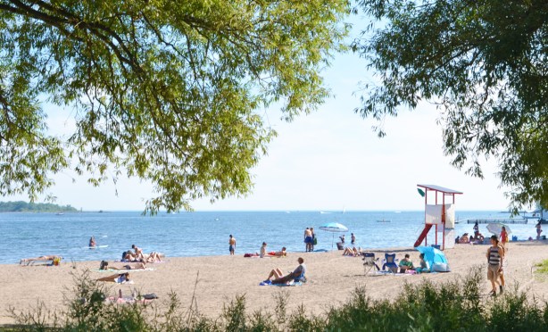 people on Cherry beach on a hot summer day, some walking, some lying or sitting on the sand