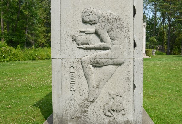 relief sculpture representing province of alberta in Guild inn garden, man holding a sheep, with rodeo cowboy beloww