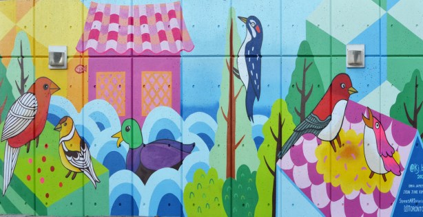 mallard duck in water and woodpecker on tree, part of Flock Together, a mural by Jieun June Kim and Erica James 