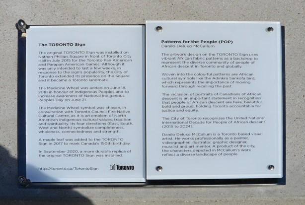 plaque beside the Toronto sign describing the history of the sign as well as the artwork that is on the new sign 