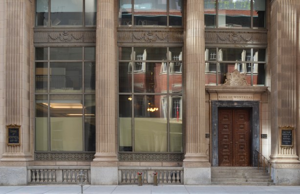 Canada Permanent Building on Bay street, with reflections of the building across the street in its large windows at street level 