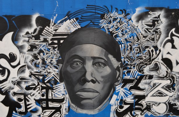 portrait of a black man in the middle surrounded by calligraphy in black and white 