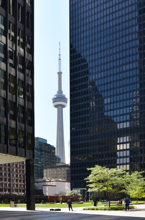 CN Tower seen between two black towers of TD bank