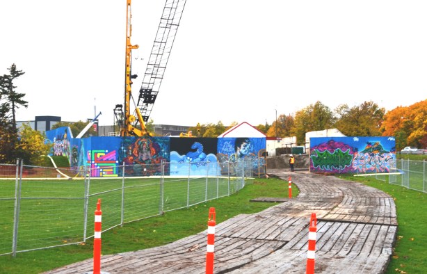 truck and vehicle entrance to construction site, orange cones, wire fence, hoardings, 