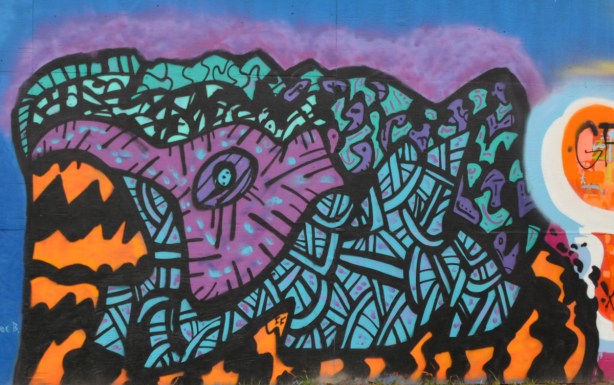 abstract geometric mural by forge fury in teal, purple, and black 