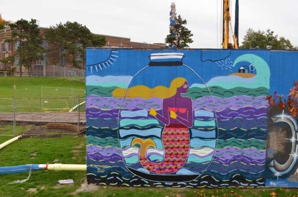 mermaid in a jar in the water, a mural