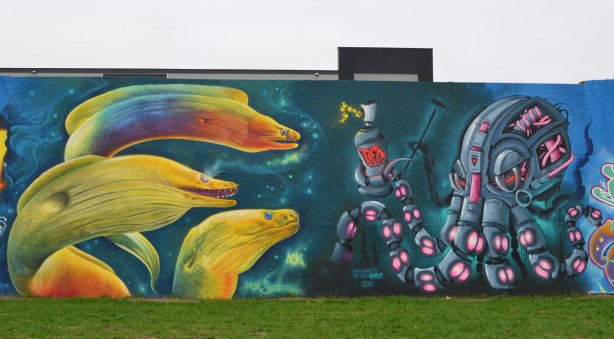 two murals. one is 3 large eel heads in yellos by Nick Sweetman, the other is a mechanical looking octopus