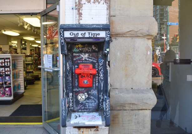 out of time, red emergency phone, street art, in old wall phone booth 
