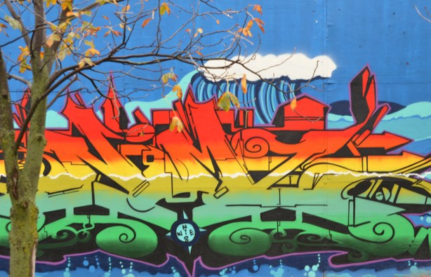 text street art in layers, red on top, yellow in the middle and green on the bottom 