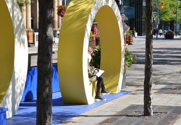 a round yellow circle around a bench on King Street, part of decorations for Tiff 