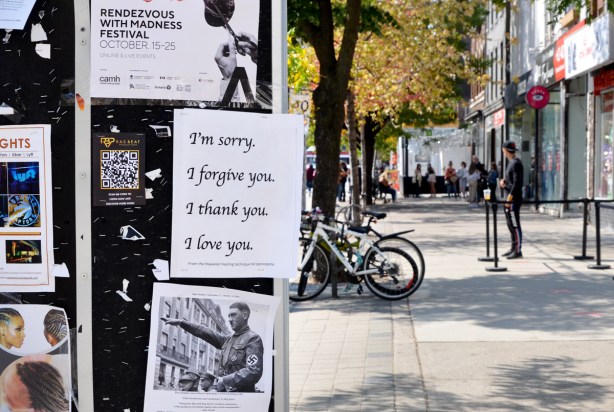 on a bulletin board, three 8 and one inch by 11 inch papers, posters in black ink, 