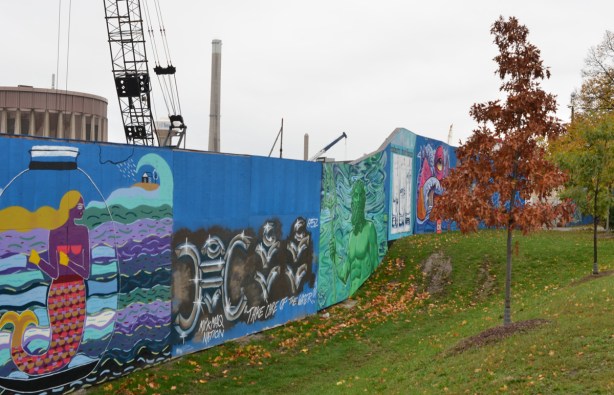 looking uphill at murals on hoardings near Ashbridge Bay water treatment facility, wallnoize project, 