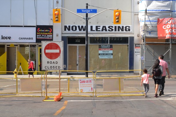 empty stores on yonge street, with a now leasing sign in the window 