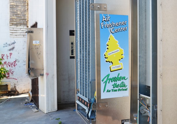 old metal air freshener dispensing machines, vending machines, empty, on the walls of an old car wash 