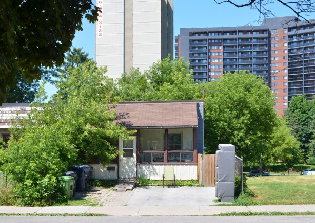 bungalow in the foreground, highrise apartment building in background