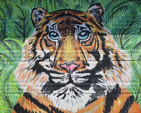 mural of a tiger's face on a garage door