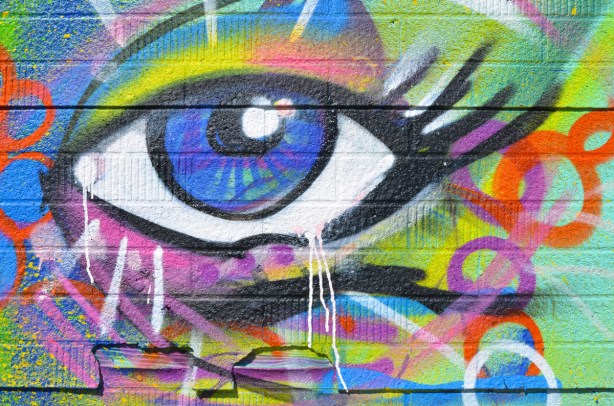 part of a street art mural, a big eye, blue in the middle