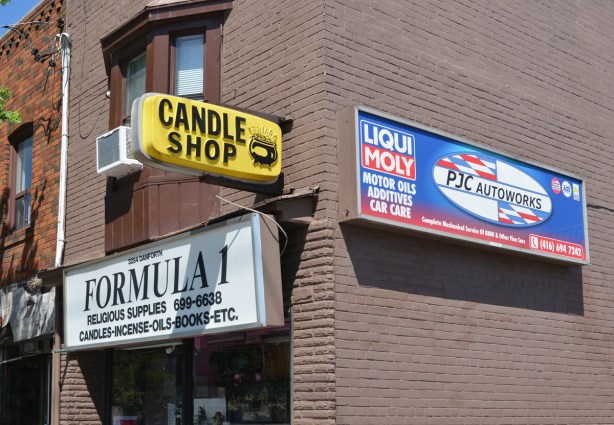 signs on exterior of store, Formula 1 store, sells candles and religious items, also sign advertising Liqui Moly motor oils, additives, and car care from PJC Autoworks