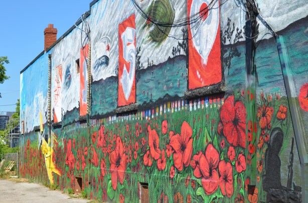 mural in the side of Royal Canadian Lion branch 73, Oakridge Branch, poppies, a yellow airplane, beside an alley, 