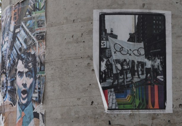 posters on a concrete utility pole