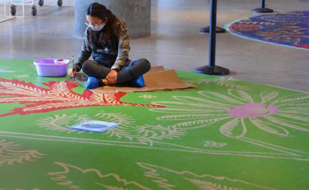 a woman painting the floor