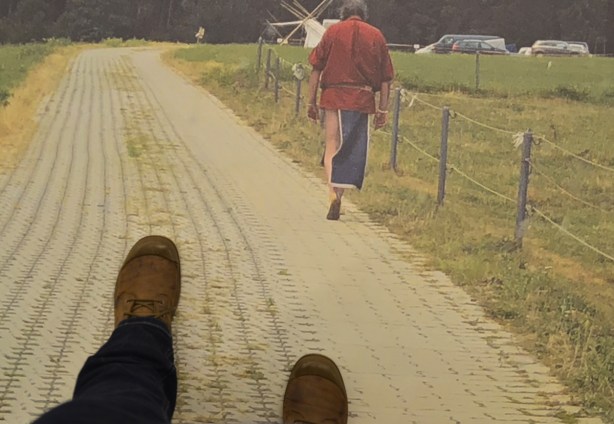 two boots walking on a picture on the floor