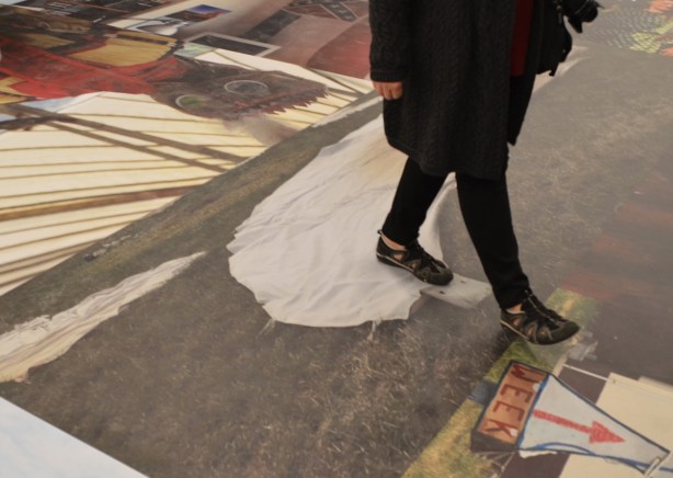 a person walking on the floor, pictures on the floor 