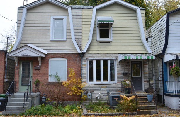 two adjacent houses with barn like rooflines, one in brick and the other in stone, 