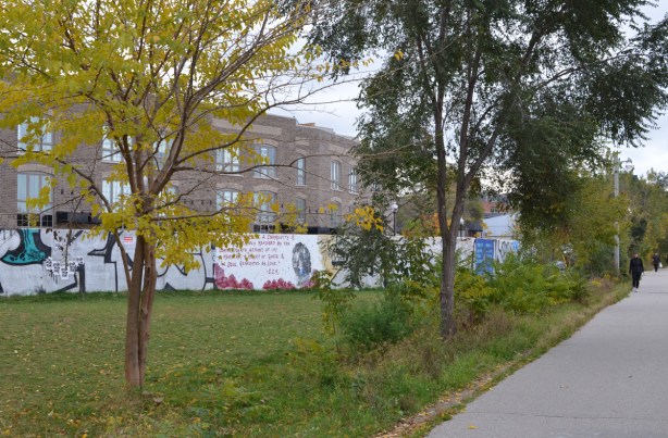 street art on hoardings around a building, west toronto rail;ath