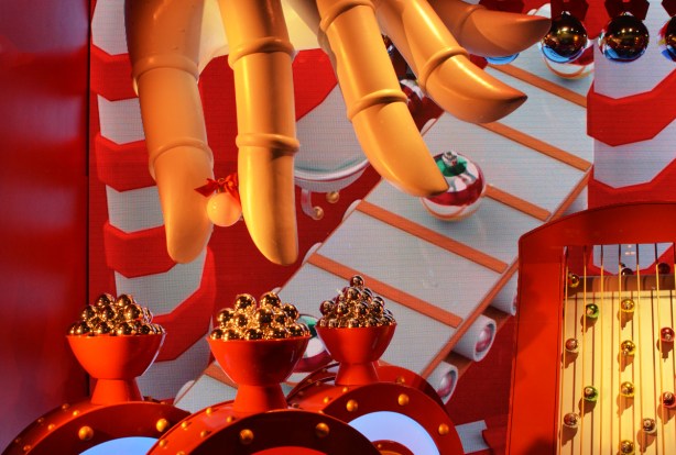 a giant hand moves shiny small round objects, robot, holiday window display at h b c store at Queen and yonge. 