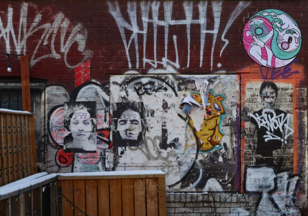 posters and paste ups on a wall in Kensington, 