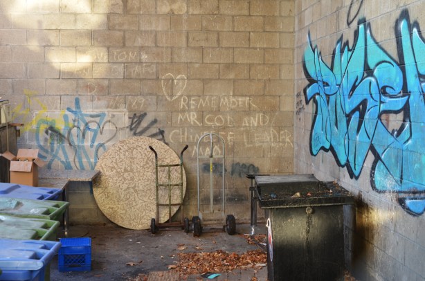 concrete wall behind store, with words that say remember chinese leader 