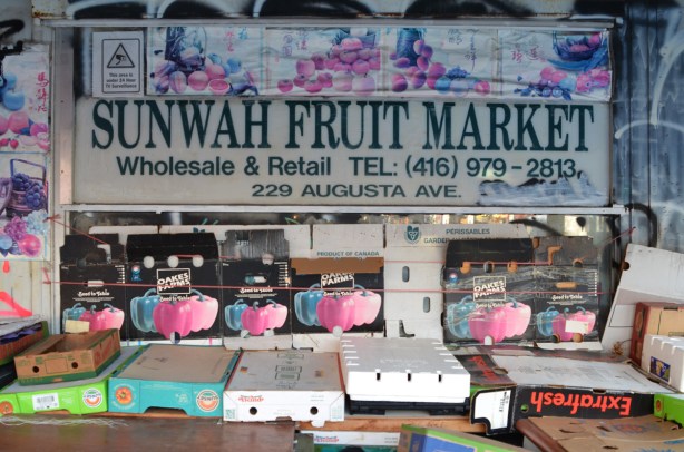 window of Sunwah fruit market in Kensington before the store opens, no food on display 