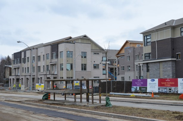 new grey townhouses being built on the Donway in Don Mills 