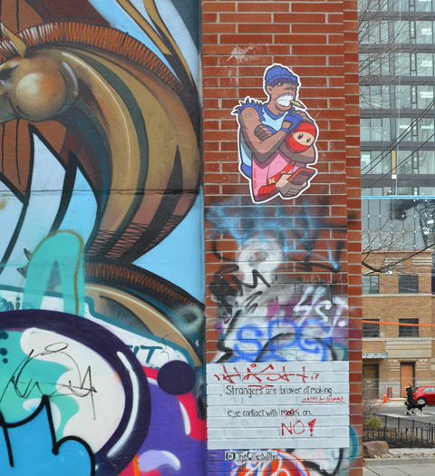 graffiti alley, urban ninja squadron paste up, t bonez in pink and red 