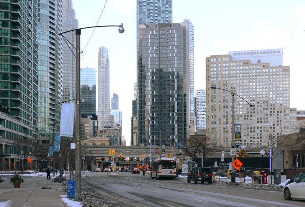 looking north up Yonge street from Queens Quay, tall buildings, not much traffic, a TTC bus,
