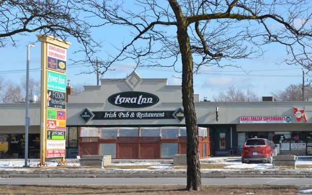 looking across Kingston Road to a stip mall with an Irish pub and the Banglabazar store, 