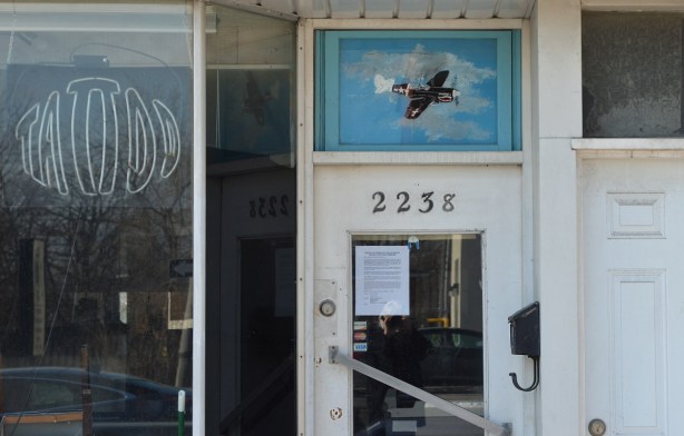 entrance to a store 2258, with a painting of an old airplane over the door 