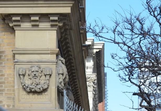 small relief sculpture high on a wall of the St. Lawrence Hall