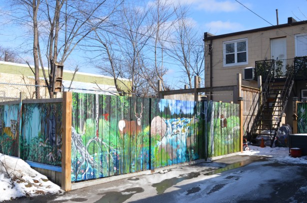 murals on a wood fence between two properties, in an alley, woodland animal theme, a deer, a moose,