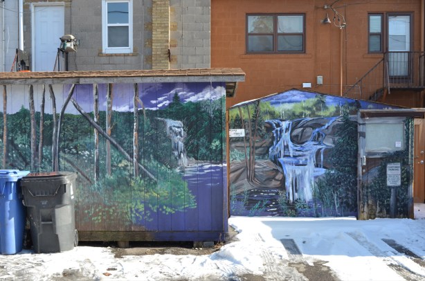 two murals in a lane, waterfall theme for both of them, the work of B C johnson 