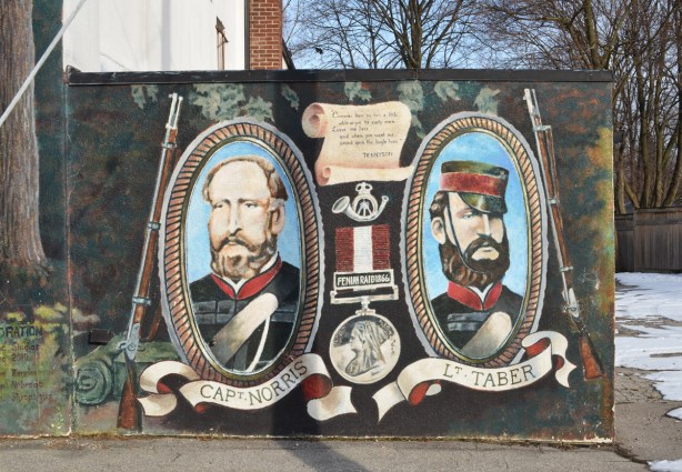 mural on side of Legion 13 building, two portraits in oval frames, Norris and Taber, Fenian Raids history