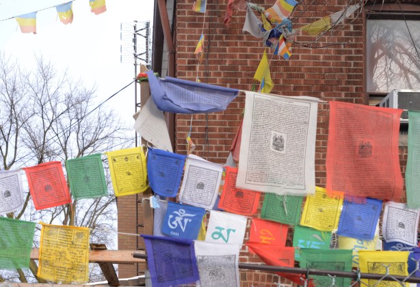 colourful Tibetan Buddhist prayer flags strung outside a store