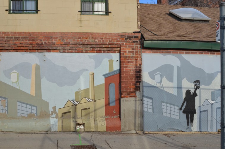 closer up view of murals in an alley