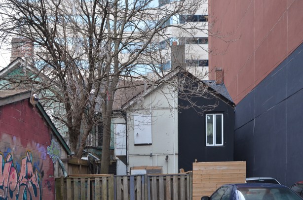 back of top part of rowhouses, seen from a lane 
