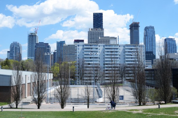 view of city skyline from Eglinton Park - looking east towards Yonge & Eglinton. Tennis courts in the foreground